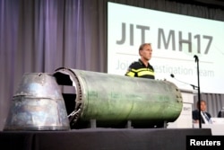 A damaged missile is displayed during a news conference by members of the Joint Investigation Team, who presented interim results in the ongoing investigation of the 2014 MH17 crash in Bunnik, Netherlands, May 24, 2018.