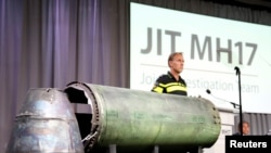 A damaged missile is displayed during a news conference by members of the Joint Investigation Team, who presented interim results in the ongoing investigation of the 2014 MH17 crash in Bunnik, Netherlands, May 24, 2018. 