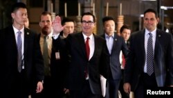 U.S. Treasury Secretary Steven Mnuchin, a member of the U.S. trade delegation to China, waves to the media as he returns to a hotel in Beijing, May 3, 2018.