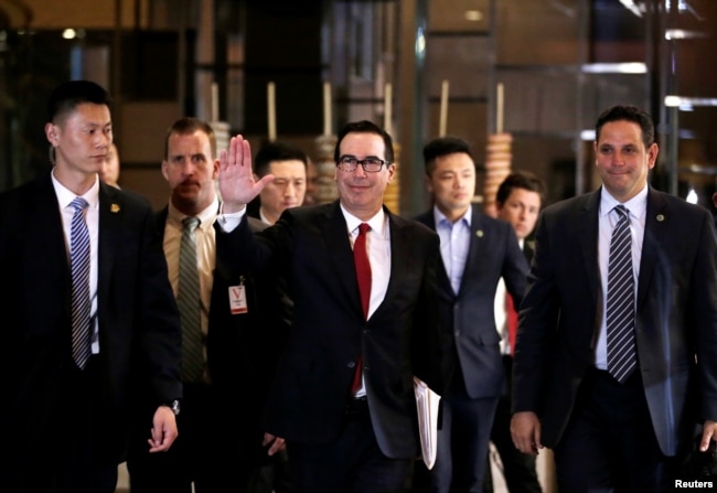 U.S. Treasury Secretary Steven Mnuchin, a member of the U.S. trade delegation to China, waves to the media as he returns to a hotel in Beijing, China, May 3, 2018.