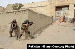 FILE - In undated photos, Pakistani troops have raided and searched suspected militant places in North Waziristan during Zarb-e-Azb counter-militancy operations.
