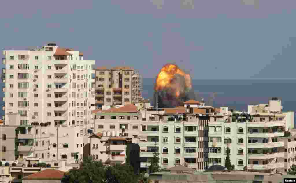 Smoke and flames are seen following what witnesses said was an Israeli air strike in Gaza City, July 25, 2014.
