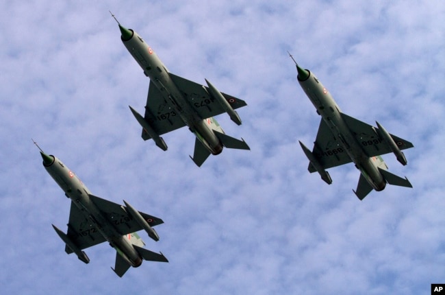 Indian Air Force MIG 21 jet fighters perform during a parade at an airbase in Tezpur, India, Nov. 21 2014.