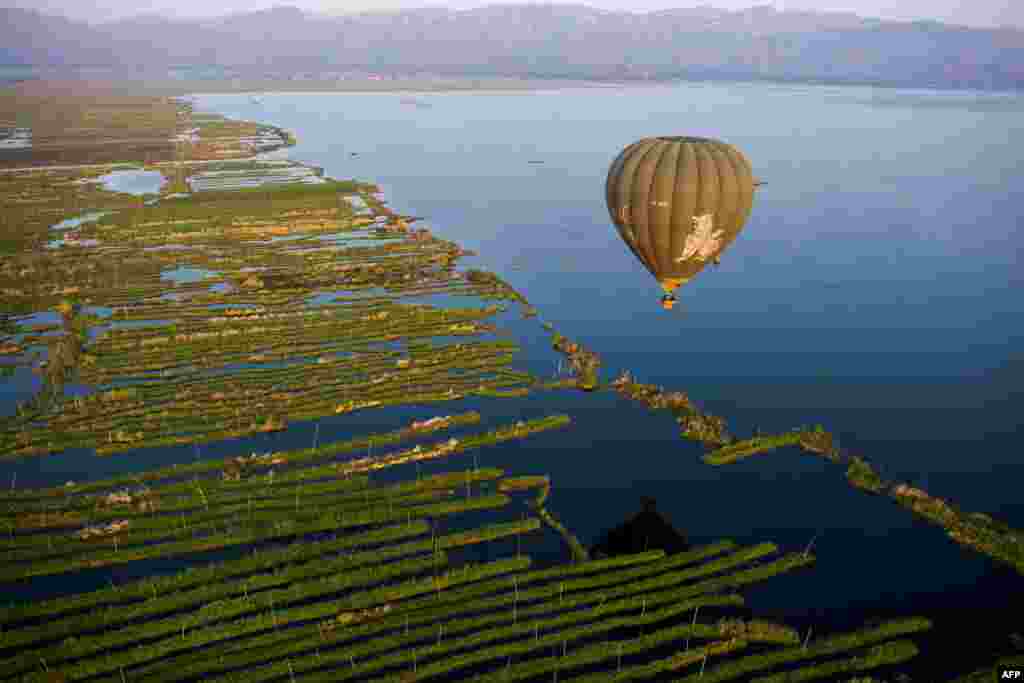 A hot air balloon flies over Inle lake in Shan State, Myanmar.