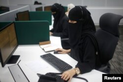 Saudi women work inside the first all-female call center in the kingdom's security sector, in the holy city of Mecca, Saudi Arabia, Aug. 29, 2017.