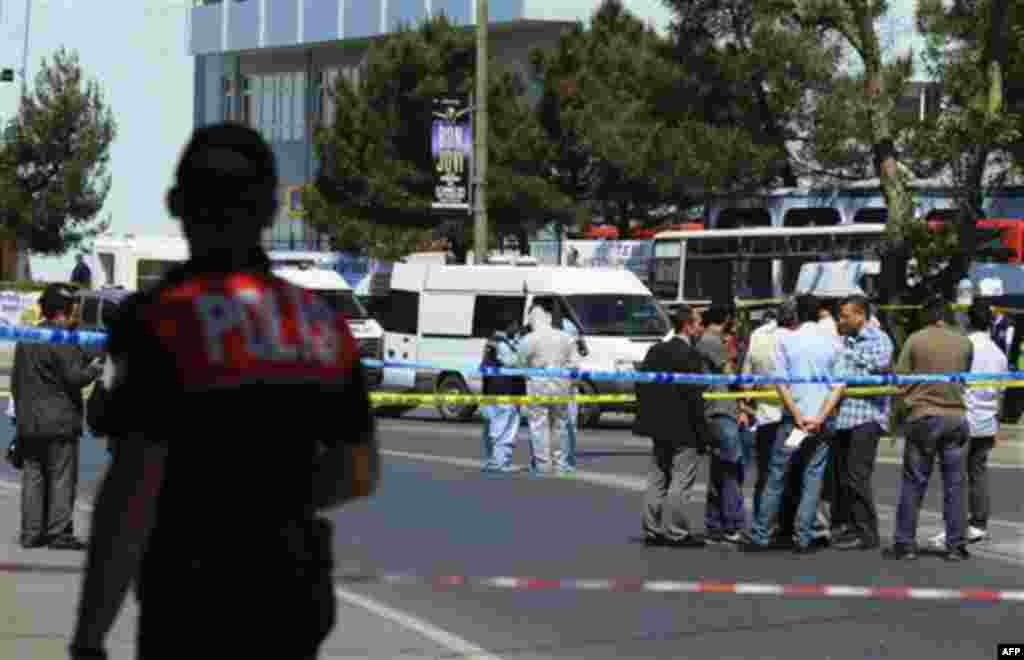 Security members and forensic experts work at the scene after a bomb exploded at a bus stop during rush hour in Istanbul, Turkey, Thursday, May 26, 2011. A bomb placed on a bicycle near a bus stop exploded during morning rush hour in Istanbul on Thursday,