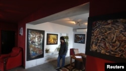 A visitor views artwork at The Venue art gallery in Kabul December 2, 2012.