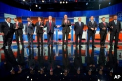 Republican presidential candidates, from left, Chris Christie, Marco Rubio, Ben Carson, Scott Walker, Donald Trump, Jeb Bush, Mike Huckabee, Ted Cruz, Rand Paul and John Kasich take the stage for their debate at Quicken Loans Arena in Cleveland, Aug. 6, 2015.