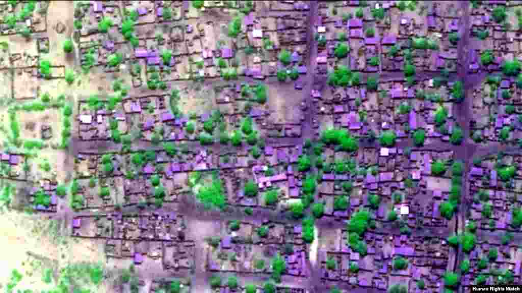 Pre-violence view of concentration of building damages (view 3). Satellite imagery displayed in false-color, near-infrared to highlight areas of extensive fire-related damages and burn scars.