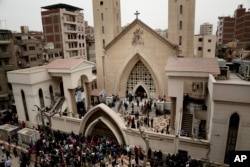 People gather outside a church in Tanta, Egypt, after a Palm Sunday bombing.