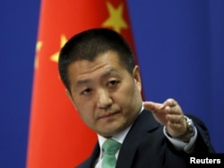 Chinese Foreign Ministry spokesman Lu Kang told reporters at a news conference that Beijing warned a U.S. Navy guided-missile destroyer that cruised close to China's man-made islands in the disputed South China Sea, in Beijing, Oct. 27, 2015.