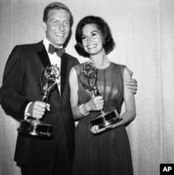 Dick Van Dyke, left, and Mary Tyler Moore co-stars of The Dick Van Dyke Show pose backstage at the Palladium with the Emmys won in the Television Academys 16th annual awards show, May 25, 1964, Los Angeles, Calif.