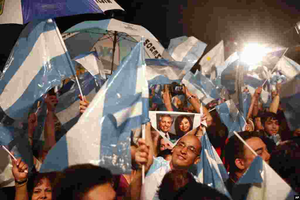 Supporters of Peronist presidential candidate Alberto Fernández and running mate, former President Cristina Fernández, celebrate after winning the presidential election in Buenos Aires, Argentina, Oct. 27, 2019.