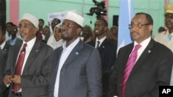 Somali President Sharif Sheik Ahmed, centre, Somali Prime Minister, Abdiwali Mohamed Ali, right, and Somali Parliament Speaker Sharif Hassan Sheik Adan, left, stand together during opening ceremony during the beginning of a nine-day meeting, July 25, 2012