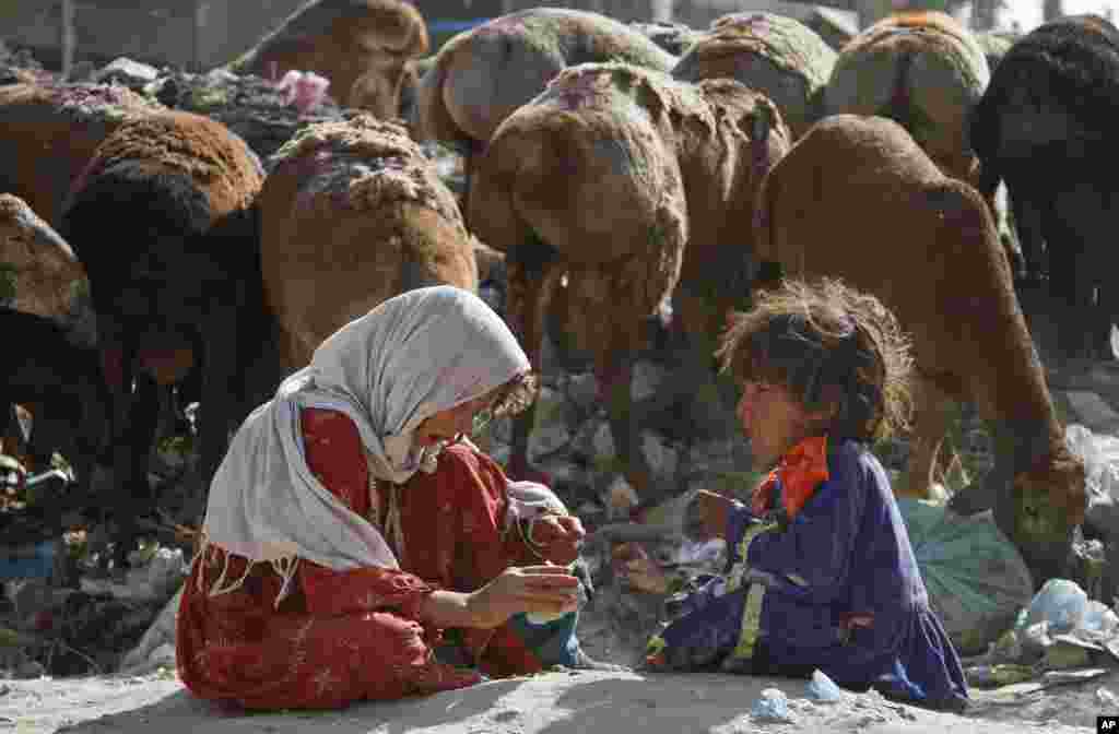 Afghan girls play at a recycling center in Kabul, Afghanistan.