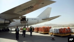 Airport workers load the first cargo plane after the Afghanistan-India air corridor inauguration ceremony at Hamid Karzai International Airport in Kabul, Afghanistan, June 19, 2017.