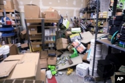 Items from two shelves that came unbolted from a wall are strewn across the floor of the stockroom of Anchorage True Value Hardware following an earthquake, Nov. 30, 2018, in Anchorage, Alaska. Store owner Tim Craig says no one was injured but hundreds of items hit the floor from shelves.