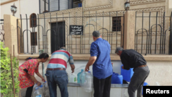 People fill gallons with water during a water shortage in Tripoli, Libya June 13, 2019. REUTERS/Hazem Ahmed