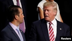 FILE - Donald Trump Jr. talks with his father, then-Republican presidential candidate Donald Trump, during the 2016 Republican National Convention in Cleveland, Ohio, July 20, 2016.