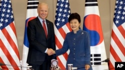 South Korean President Park Geun-hye, right, shakes hands with U.S. Vice President Joe Biden before their meeting at the presidential Blue House in Seoul, South Korea, Friday, Dec. 6, 2013.
