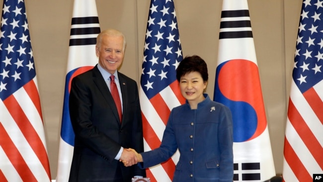 South Korean President Park Geun-hye, right, shakes hands with U.S. Vice President Joe Biden before their meeting at the presidential Blue House in Seoul, South Korea, Friday, Dec. 6, 2013.