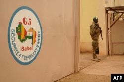 FILE - A Malian Army soldier with the G5 Sahel, an institutional framework for coordination of regional cooperation in development policies and security matters in West Africa, is seen in Sevare, May 30, 2018.
