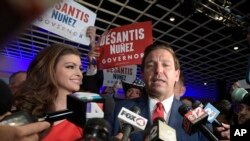 Florida Governor-elect Ron DeSantis, right, answers questions from reporters, with his wife Casey, after being declared the winner of the Florida gubernatorial race at an election party in Orlando, Fla., Nov. 6, 2018.