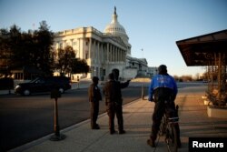 U.S. Capitol policemen stand in front of the Capitol before President Donald Trump delivers his first State of the Union address in Washington, Jan. 30, 2018.