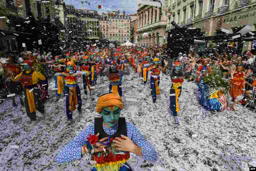 Dancers perform in a parade of the 18th edition of the Lyon Dance Biennial on a street in Lyon, eastern France.