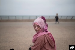 In this Wednesday, July 24, 2019 photo, Fatimazehra Belloucy, 25, a woman affected by a rare disorder called xeroderma pigmentosum, or XP, poses for a portrait in Casablanca, Morocco. (AP Photo/Mosa'ab Elshamy)