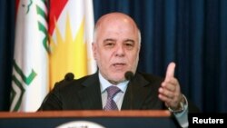 FILE - Iraqi Prime Minister Haider al-Abadi addresses the media during a news conference. Iraq's parliament voted on Nov. 1, 2015, to limit the powers of the country's prime minister in passing reforms, forcing him to seek approval by lawmakers for enacting new measures.