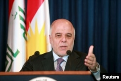 FILE - Iraqi Prime Minister Haider al-Abadi addresses the media during a news conference.