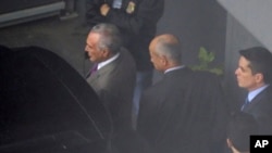 FILE - In this photo shot through a fence, former Brazilian President Michel Temer, left, is seen at the international airport in Sao Paulo, Brazil, March 21, 2019.