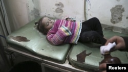 FILE - A girl receives treatment in a field hospital in Aleppo, Syria, December 28, 2013.
