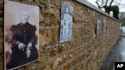 A photo of French WWI soldier Augustin Trebuchon, taken Oct. 30, 2018, hangs on a wall outside a cemetery in Vrigne-Meuse, France.