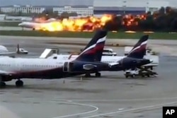 This image taken from video provided by Instagram user @artempetrovich, shows the SSJ-100 aircraft of Aeroflot Airlines on fire during an emergency landing in Sheremetyevo airport in Moscow, Russia, May 5, 2019.