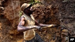 One of few remaining miners digs out soil which will later be filtered for traces of cassiterite, the major ore of tin, at Nyabibwe mine, in eastern Congo, Aug. 7, 2012.