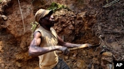 One of few remaining miners digs out soil which will later be filtered for traces of cassiterite, the major ore of tin, at Nyabibwe mine, in eastern Congo, Aug. 7, 2012.