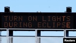 A sign on the highway refers to the upcoming solar eclipse near Guernsey, Wyoming, Aug. 19, 2017. 