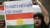 A Kurd opposed to Syrian President Bashar Assad shouts slogans during a sit-in in front of the Syrian embassy, in Beirut, Lebanon, Sunday, Oct. 23, 2011