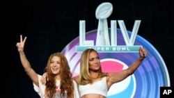 NFL Super Bowl 54 football game halftime performer Jennifer Lopez and Shakira pose for a picture after a news conference Thursday, Jan. 30, 2020, in Miami. 