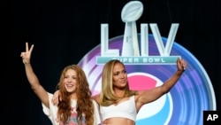 NFL Super Bowl 54 football game halftime performer Jennifer Lopez and Shakira pose for a picture after a news conference Thursday, Jan. 30, 2020, in Miami. (AP Photo/David J. Phillip)
