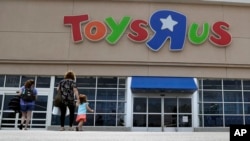 FILE - Shoppers walk into a Toys R Us store, in San Antonio, Texas, Sept. 19, 2017. 