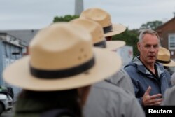 FILE - U.S. Interior Secretary Ryan Zinke talks to National Park Service rangers while traveling for his National Monuments review process, in Boston, Massachusetts, June 16, 2017.