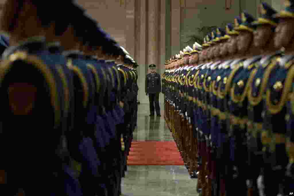 Members of a Chinese honor guard prepare for a welcome ceremony for Russian Prime Minister Dmitry Medvedev at the Great Hall of the People in Beijing.