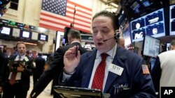 FILE - A trader on the floor of the New York Stock Exchange.