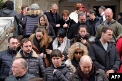 Mourners leave the service of remembrance at the Saint Etienne Church in Trebes in southwest France, March 25, 2018, two days after Radouane Lakdim carried out an attack in which four people were killed.