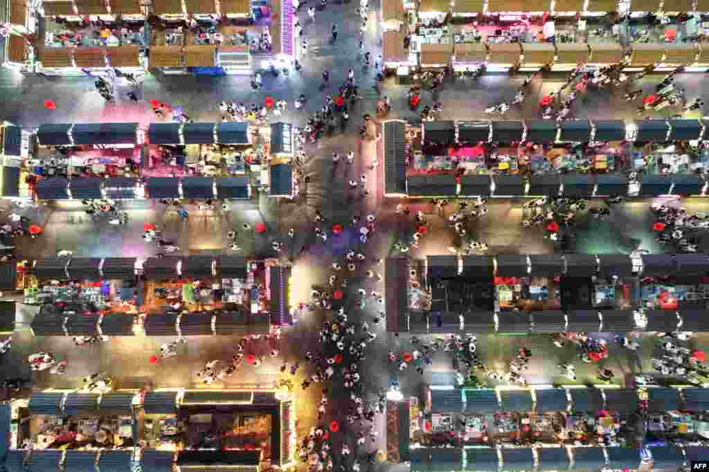 This aerial photo shows people visiting a night market in Shenyang in China&#39;s northeastern Liaoning province, June 16, 2020.