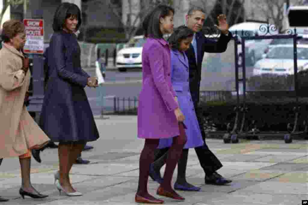 President Barack Obama, accompanied by his daughters Sasha and Malia, first lady Michelle Obama and mother-in-law Marian Robinson, waves as they arrive at St. John's Church in Washington, Monday, Jan. 21, 2013, for a church service during the 57th Preside