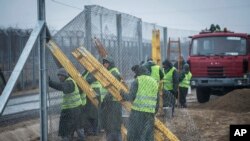 Prison inmates build a second protective fence on the border between Hungary and Serbia, near Kelebia, 178 kilometers southeast of Budapest, Hungary, March 1, 2017.